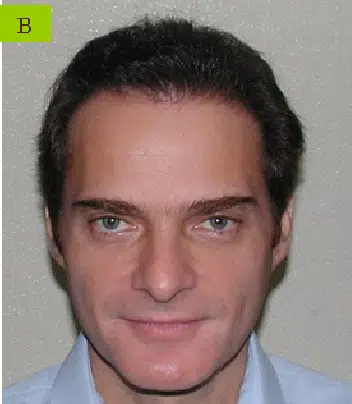 Headshot of a man with dark hair and green eyes, wearing a light blue collared shirt. The background is neutral and plain, focusing on his facial features. This image can be used in professional contexts, such as a biography or profile, to convey a friendly and approachable demeanor.